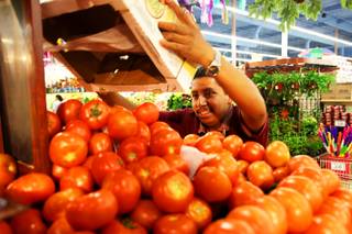 Misael Barrera stocks the produce at Cardenas Market on Meadows Lane on Saturday, May, 28, 2011. Cardenas, which caters to the Hispanic population, is thriving in this down economy.