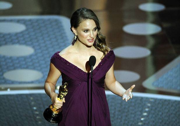 Natalie Portman accepts the Oscar for best performance by an actress in a leading role for "Black Swan" at the 83rd Academy Awards on Sunday, Feb. 27, 2011, in the Hollywood section of Los Angeles.