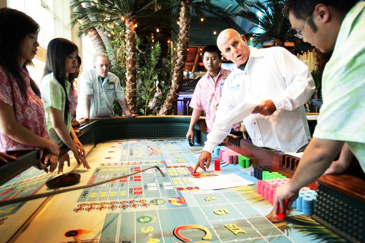 A floor supervisor trains the craps table dealers at the Margaritaville casino inside the Flamingo on Friday, Sept. 30, 2011. 