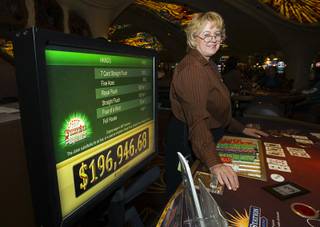 Galina Burnip deals at a Pai Gow table at Sunset Station Casino in Henderson Oct. 27, 2011. Station Casino's have linked their Pai Gow tables to enable progressive jackpots.