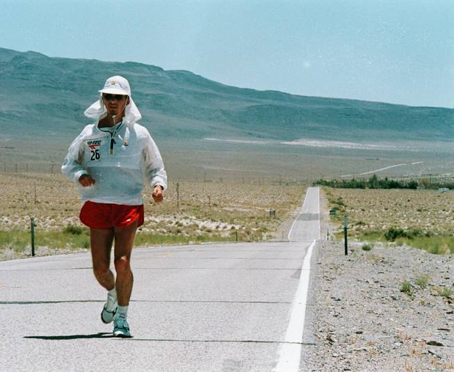 A man runs along Highway 136 during the the Death Valley Marathon. Upcoming running events in Death Valley National Park are scheduled for February. People who don't want to wait for winter to see the beauty of the national park can go to Furnace Creek Resort to play a round of golf.