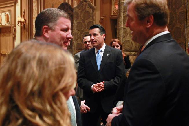 Nevada Governor Brian Sandoval and Sen. Dean Heller, right, talk with guests at the Nevada Development Authority's annual luncheon Friday, Dec. 7, 2012.