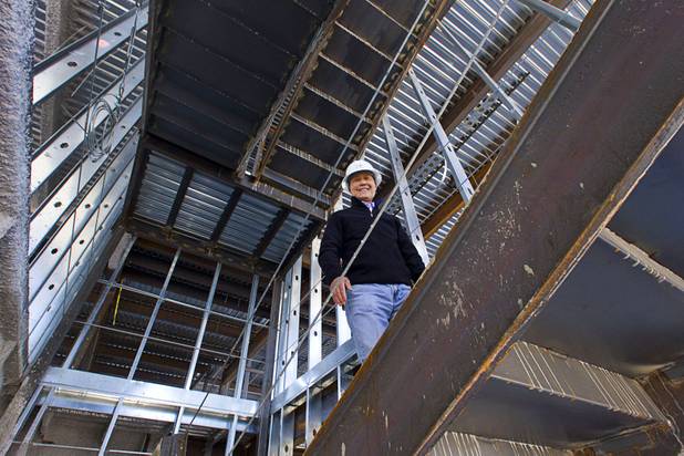 Steven Kwon, president of GKG Builders, climbs stairs during a tour of the Peace Palace, a Unification Church convention and training center, under construction at 6590 Bermuda Road Monday, April 7, 2014.