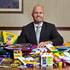Bryan Lindsey ,VP/General Manager at Station Casinos, is surrounded by some of the school supplies which will be distributed to students in need.