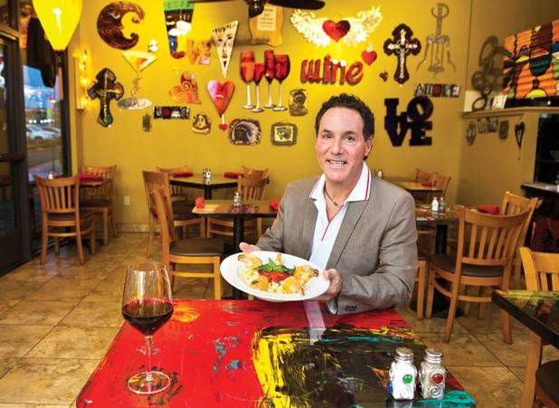 David Alenik, owner of Pasta Shop Ristorante & Art Gallery, shows off a specialty dish. 