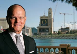 Terry Lanni, former chairman of the board and CEO of then-MGM Mirage, poses at the Bellagio in September 2007. Construction cranes from the CityCenter project can be seen at right.