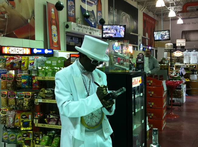Rapper and reality television star Flavor Flav signs a bottle of his LeFLAV vodka at Lee's Discount Liquor on Lake Mead Boulevard on Dec. 23, 2011.