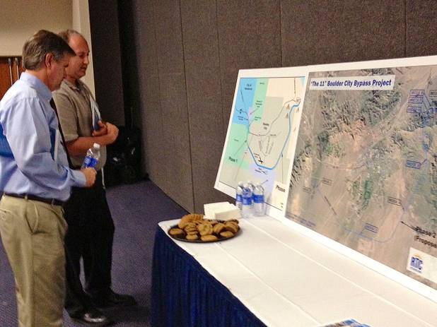 Mike Hand, director of engineering services for streets and highways for the Regional Transportation Commission of Southern Nevada, and Shawn "Jamie" Johnson of the Greater Las Vegas Association of Realtors review maps at Thursday's Interstate 11 informational meeting at the Henderson Convention Center.