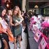 Photo: Women look over items in the silent auction during
