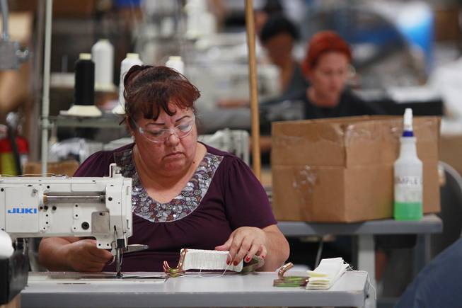 Sewing technicians work at Creative Tent International July 30, 2014.